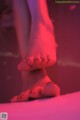 A close up of a person's bare feet in a bathtub.