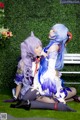 A couple of women sitting on top of a white bench.