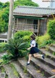 A woman in a school uniform is running up some steps.